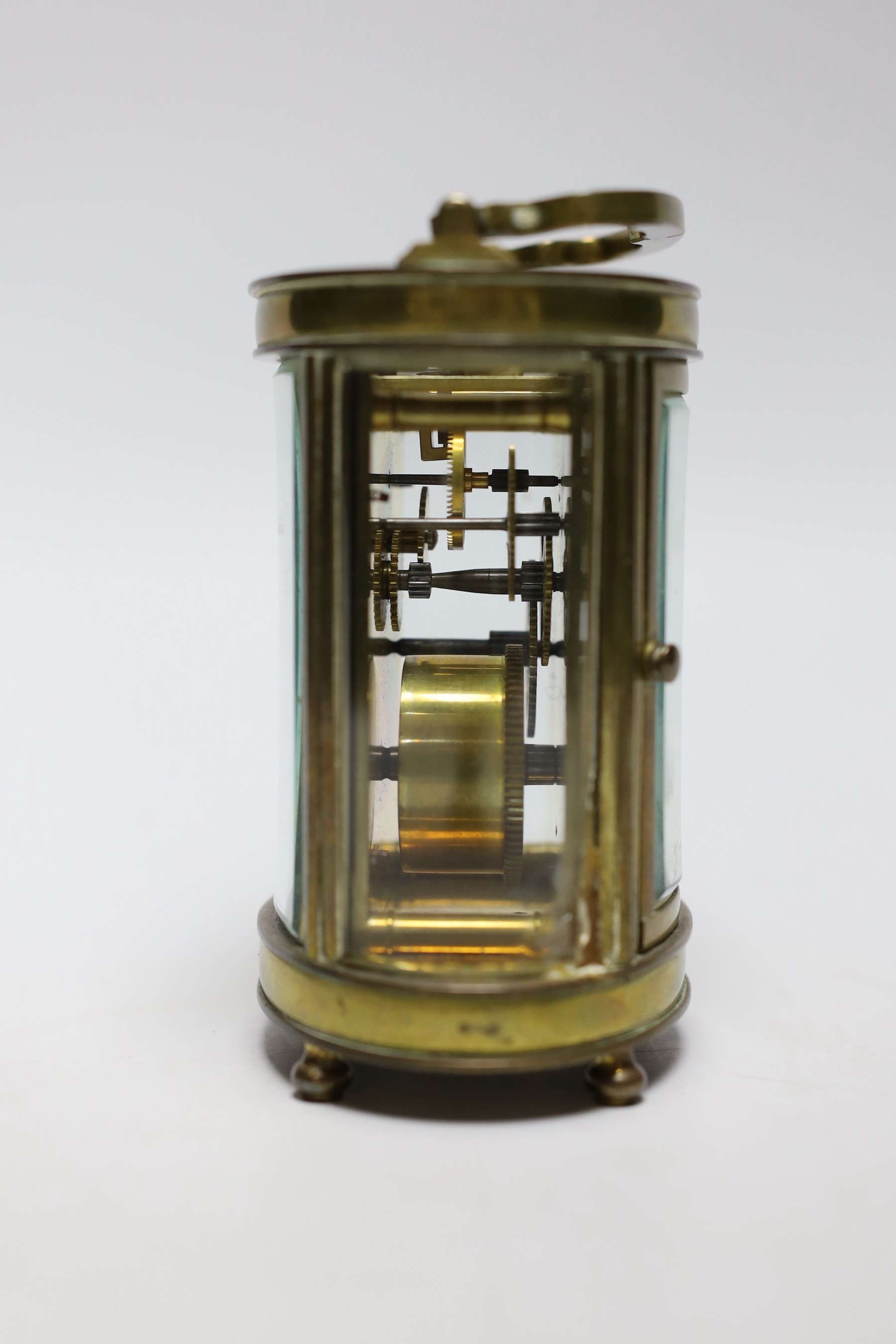 A French oval brass carriage timepiece, 11cms high